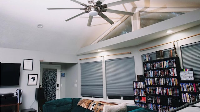 living room featuring ceiling fan and lofted ceiling