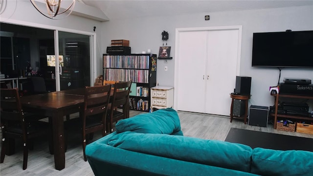 living room with hardwood / wood-style floors and a notable chandelier