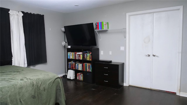 bedroom with dark wood-type flooring