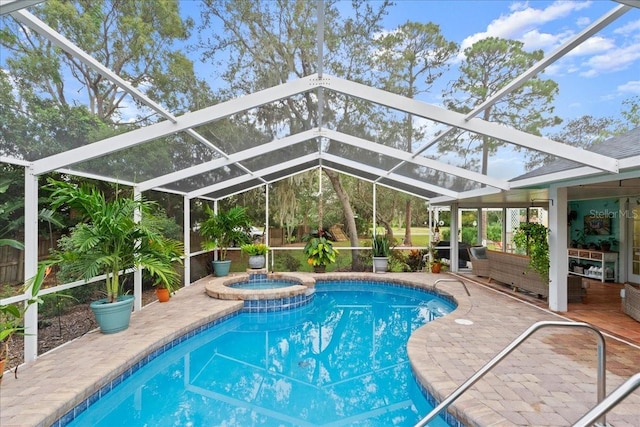 view of swimming pool with a lanai, a patio area, and an in ground hot tub