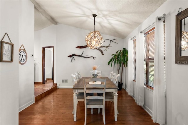 dining room with vaulted ceiling with beams, dark hardwood / wood-style floors, and a healthy amount of sunlight