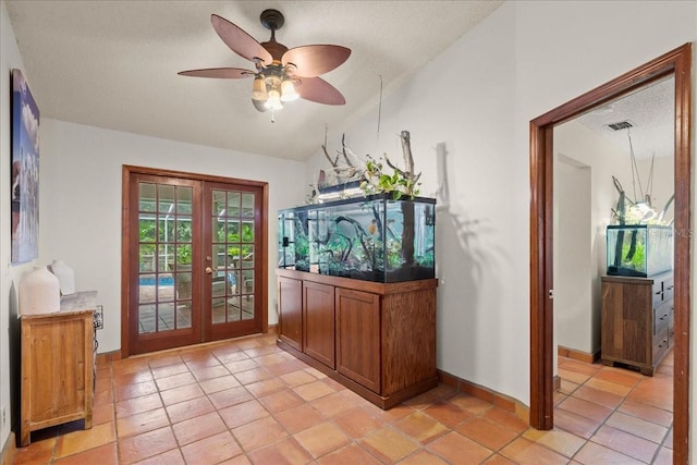 entryway featuring vaulted ceiling, a textured ceiling, and french doors