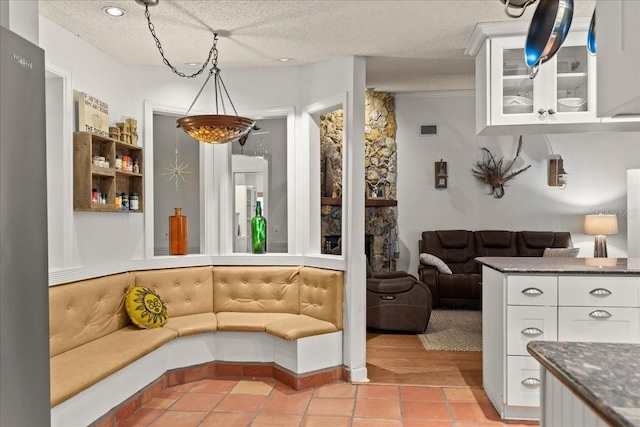 living room with light tile patterned floors and a textured ceiling