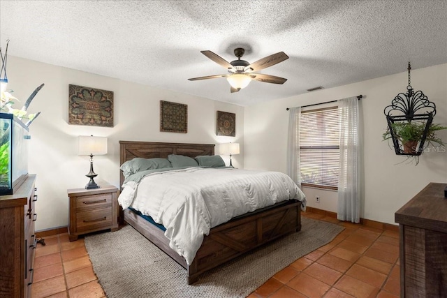 tiled bedroom with a textured ceiling and ceiling fan