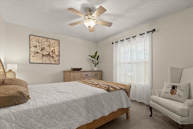 bedroom with carpet, a textured ceiling, and ceiling fan