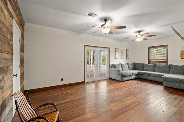 unfurnished living room featuring ceiling fan, wood-type flooring, and french doors