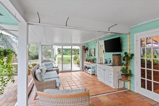 sunroom / solarium with a healthy amount of sunlight and sink