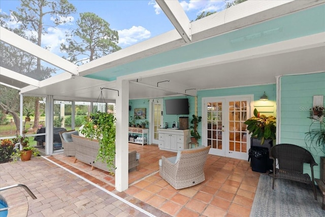 view of patio / terrace featuring glass enclosure and french doors