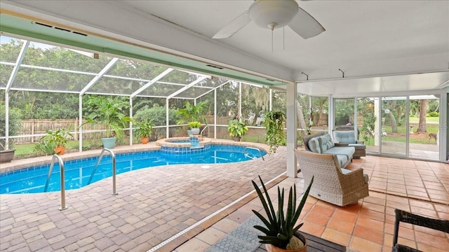 view of pool with a lanai, a patio area, ceiling fan, and an in ground hot tub