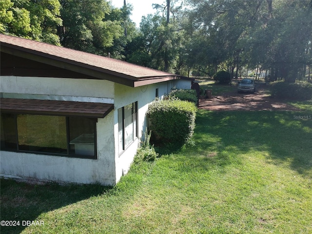 view of property exterior featuring a lawn