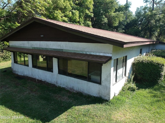 view of home's exterior with a yard