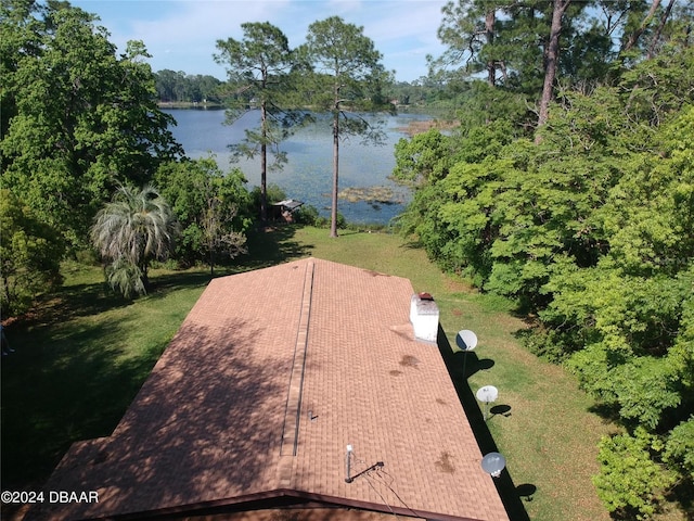 surrounding community with a lawn and a water view