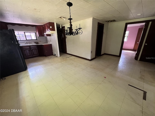 unfurnished dining area featuring a chandelier