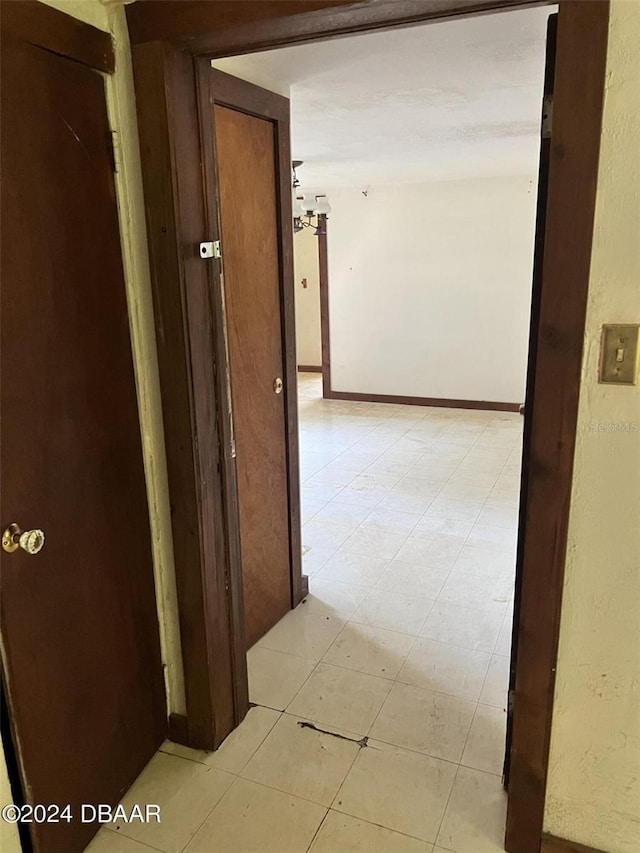 hall featuring light tile patterned flooring