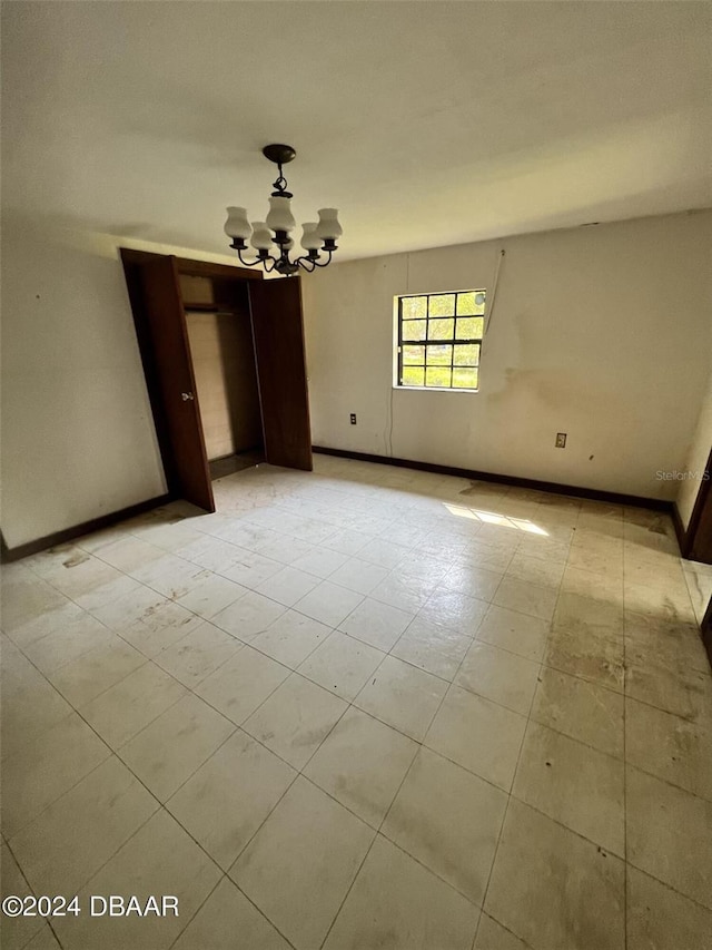 empty room with a notable chandelier