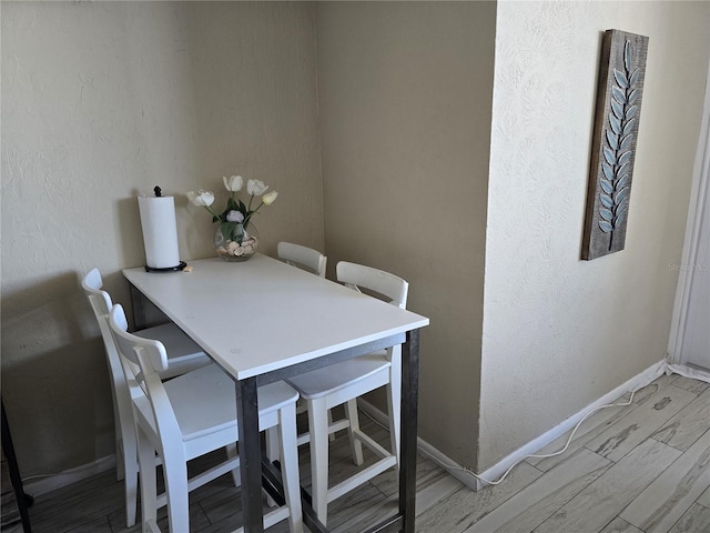 dining area with light hardwood / wood-style floors