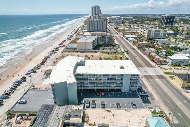 bird's eye view featuring a water view and a beach view