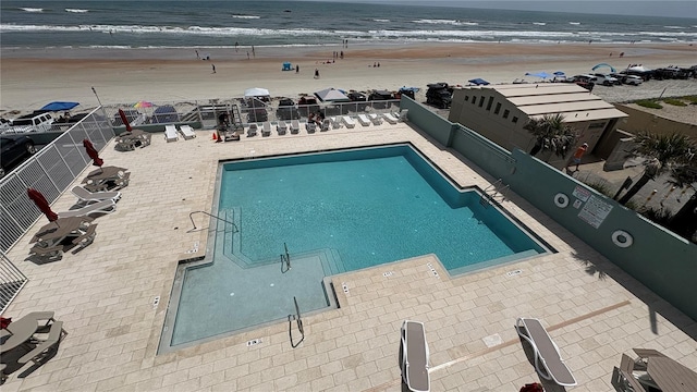 800 N Atlantic Ave Unit 407, Daytona Beach, FL 32118 - pool with a view of the beach, a patio, a water view, and fence