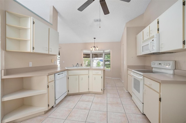 kitchen featuring kitchen peninsula, white appliances, ceiling fan with notable chandelier, light tile patterned floors, and decorative light fixtures