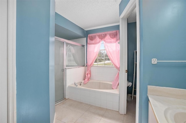 bathroom featuring tile patterned floors, vanity, independent shower and bath, and a textured ceiling