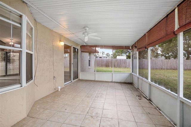 unfurnished sunroom with ceiling fan