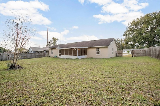 back of house with a lawn