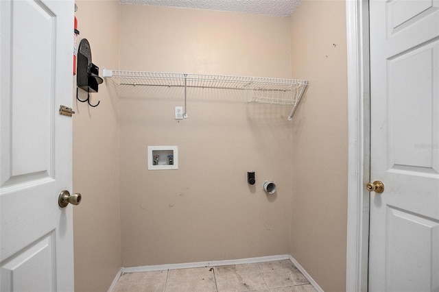 clothes washing area featuring hookup for a washing machine, a textured ceiling, electric dryer hookup, and light tile patterned flooring