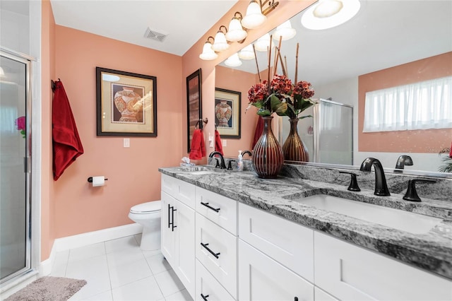 bathroom featuring tile patterned flooring, vanity, a shower with door, and toilet