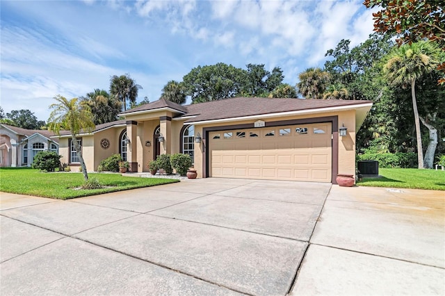 ranch-style home featuring a front yard, a garage, and central AC unit