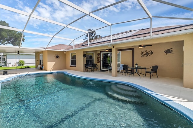 view of swimming pool with a lanai, a patio area, and ceiling fan