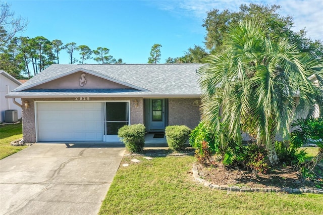 ranch-style home with cooling unit, a front yard, and a garage