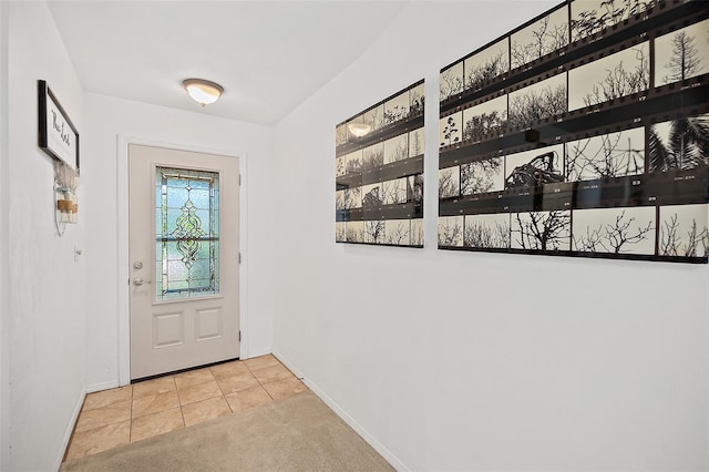 doorway to outside with light tile patterned floors