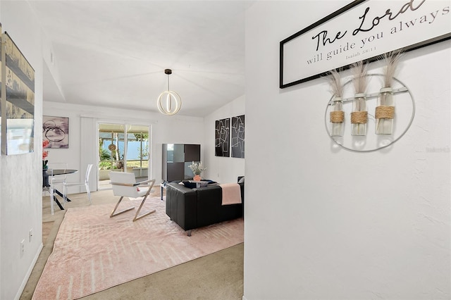 carpeted living room featuring lofted ceiling