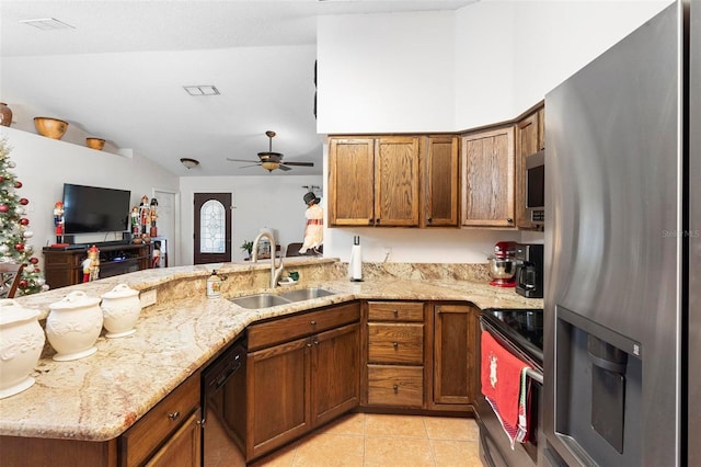 kitchen featuring kitchen peninsula, sink, light tile patterned floors, and stainless steel appliances