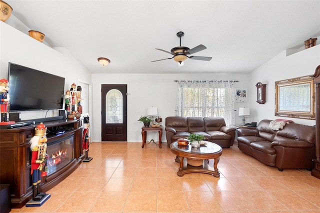 tiled living room with ceiling fan and vaulted ceiling