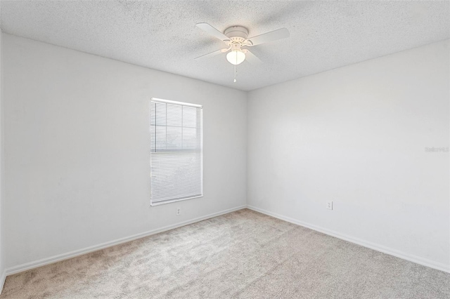 empty room featuring carpet flooring, a textured ceiling, and ceiling fan