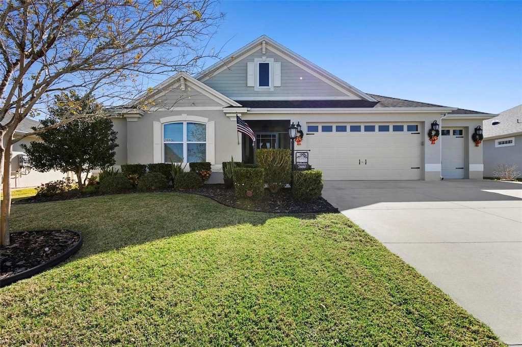 view of front facade with a garage and a front lawn