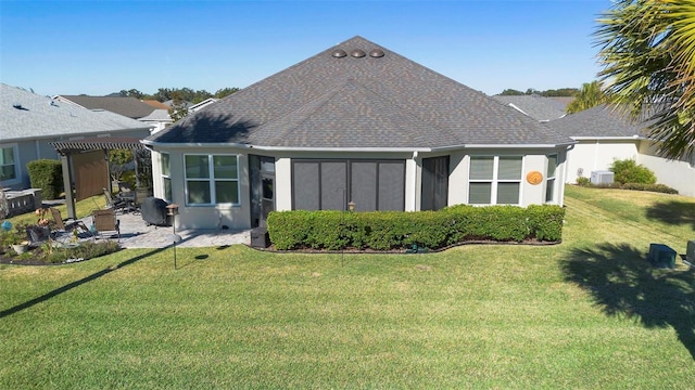 back of property with a lawn and a patio area