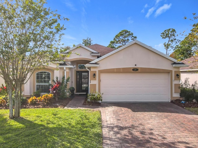 view of front of home featuring a garage and a front lawn