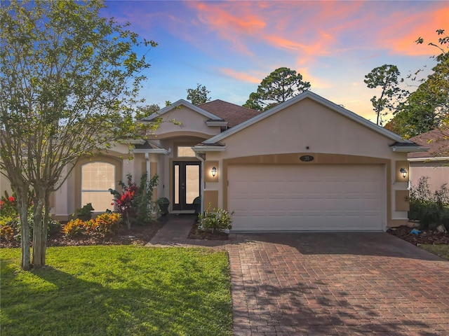 view of front of house with a yard and a garage