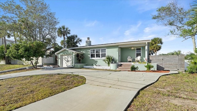 ranch-style home with a porch, a garage, and a front lawn