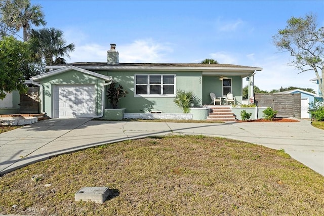 single story home featuring a front lawn, covered porch, and a garage