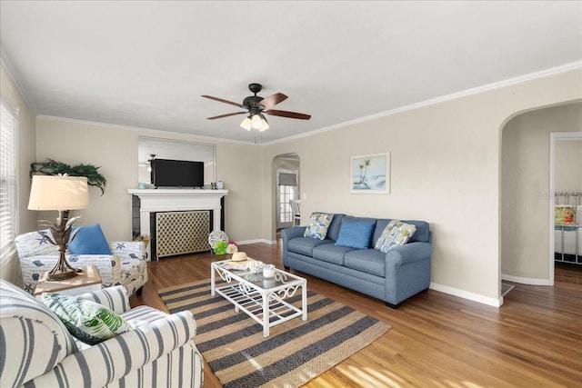 living room featuring ornamental molding, a healthy amount of sunlight, and hardwood / wood-style flooring