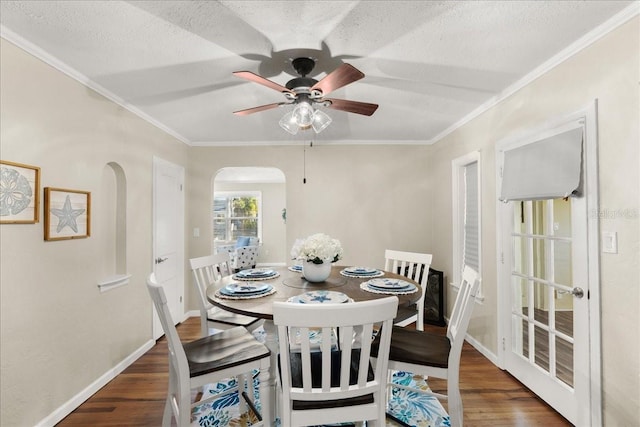 dining space with dark hardwood / wood-style floors, ceiling fan, and a textured ceiling