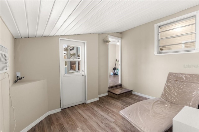 sitting room with light hardwood / wood-style floors and vaulted ceiling