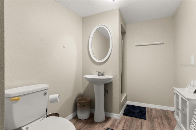 bathroom featuring hardwood / wood-style floors and toilet