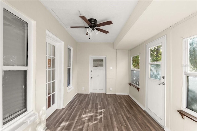 unfurnished sunroom featuring ceiling fan