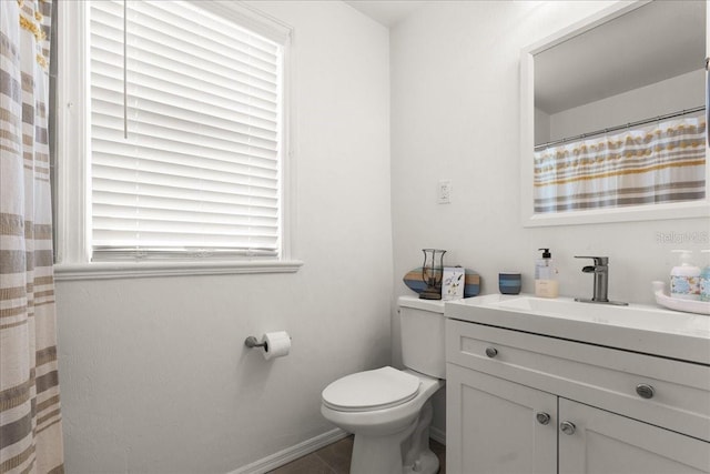 bathroom featuring tile patterned floors, vanity, and toilet