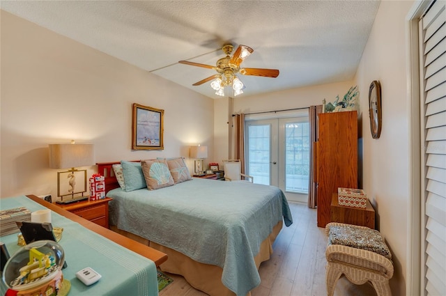 bedroom with a textured ceiling, ceiling fan, access to exterior, and light hardwood / wood-style floors