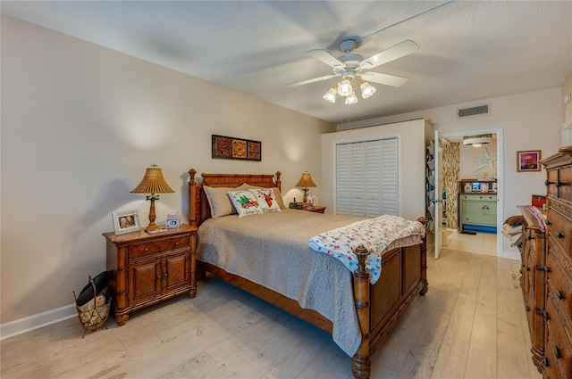 bedroom with ceiling fan, a closet, and light wood-type flooring